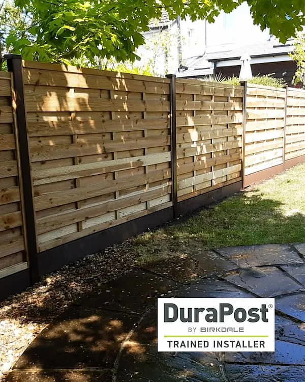 Durapost fence with horizontal timber panels supported by galvanised steel posts Keywords: Durapost, galvanised steel fence posts, timber fencing, horizontal fence panels, low-maintenance fencing, modern garden fence