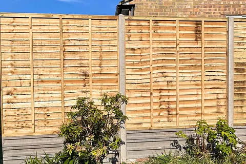 New overlap panel fencing with concrete posts installed in a residential garden in East Grinstead