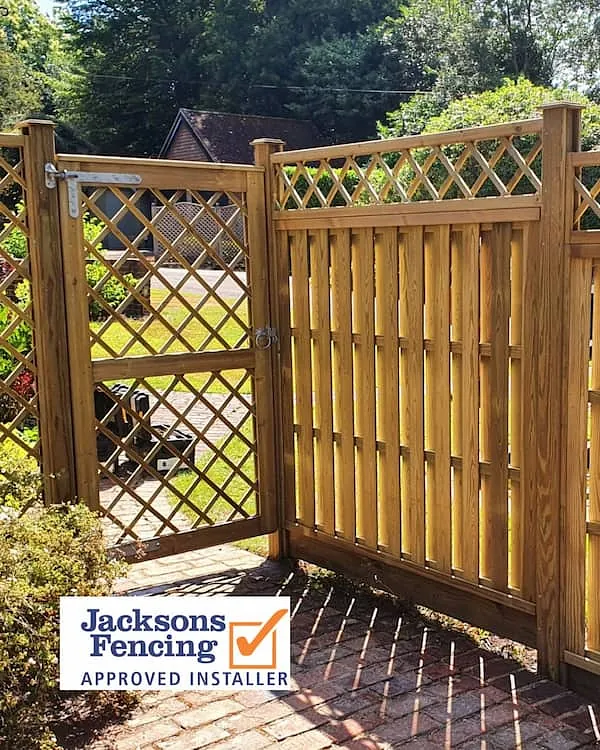 Jacksons Fencing wooden gate with trellis panel in a sunny garden setting Keywords: Jacksons Fencing, wooden garden gate, trellis garden gate, timber fencing, Jacksons timber products, garden gate design